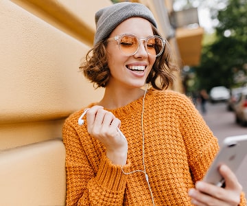 Happy woman watching online courses on a smartphone